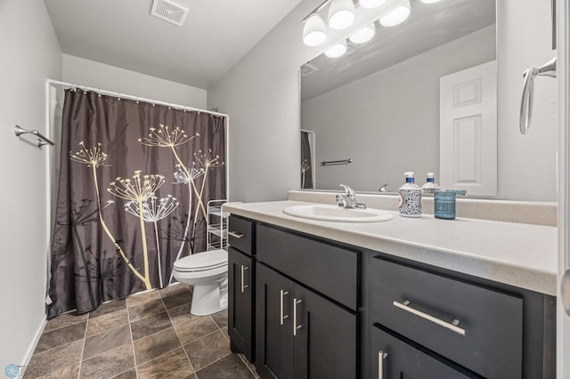 full bathroom with vanity, a shower with shower curtain, toilet, and visible vents