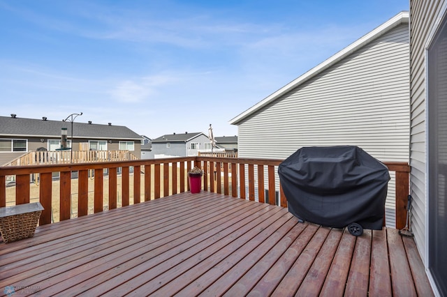 wooden deck with a residential view and grilling area