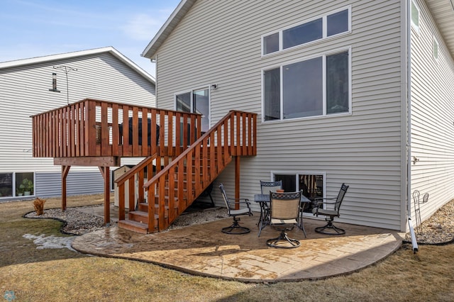 rear view of house with a deck, stairway, and a patio area