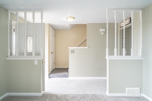 corridor featuring baseboards, visible vents, and carpet floors