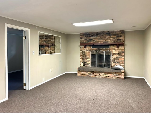 unfurnished living room with baseboards, carpet, ornamental molding, and a fireplace