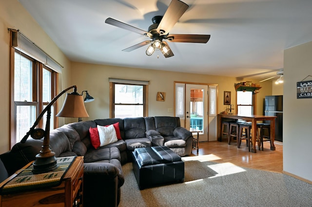 living room featuring wood finished floors and ceiling fan