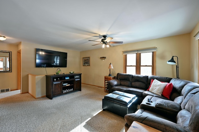 living room featuring visible vents, baseboards, light colored carpet, and a ceiling fan