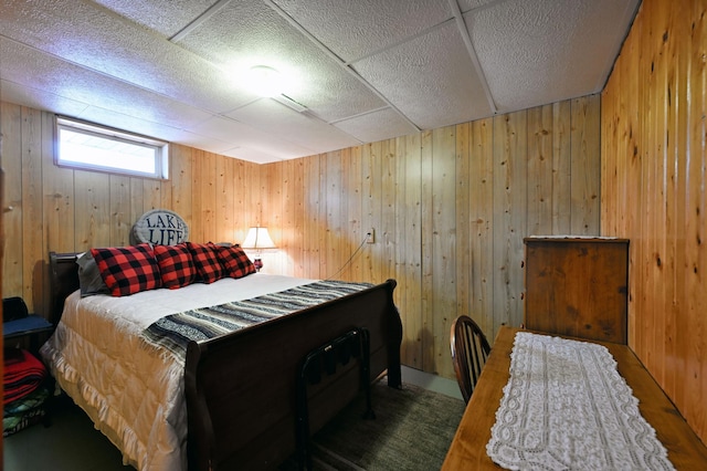 bedroom featuring wooden walls