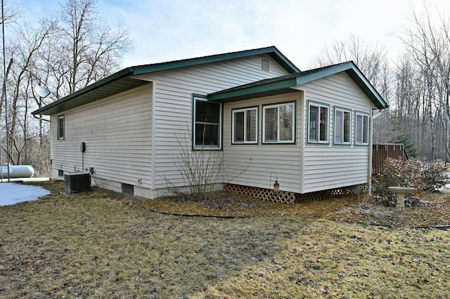 view of side of property with central air condition unit