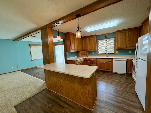 kitchen featuring dark wood finished floors, beamed ceiling, light countertops, brown cabinetry, and white appliances