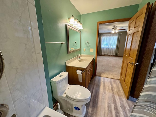 full bath with ceiling fan, toilet, wood finished floors, and vanity