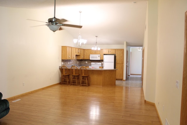 12170 Hillcrest Ct SE, Becker, MN 55308 - kitchen featuring white appliances, a peninsula, a chandelier, decorative backsplash, and a ceiling fan