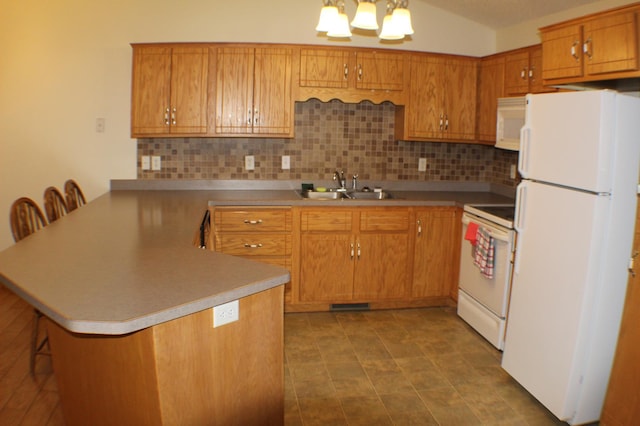 12170 Hillcrest Ct SE, Becker, MN 55308 - kitchen with white appliances, a peninsula, tasteful backsplash, and brown cabinetry