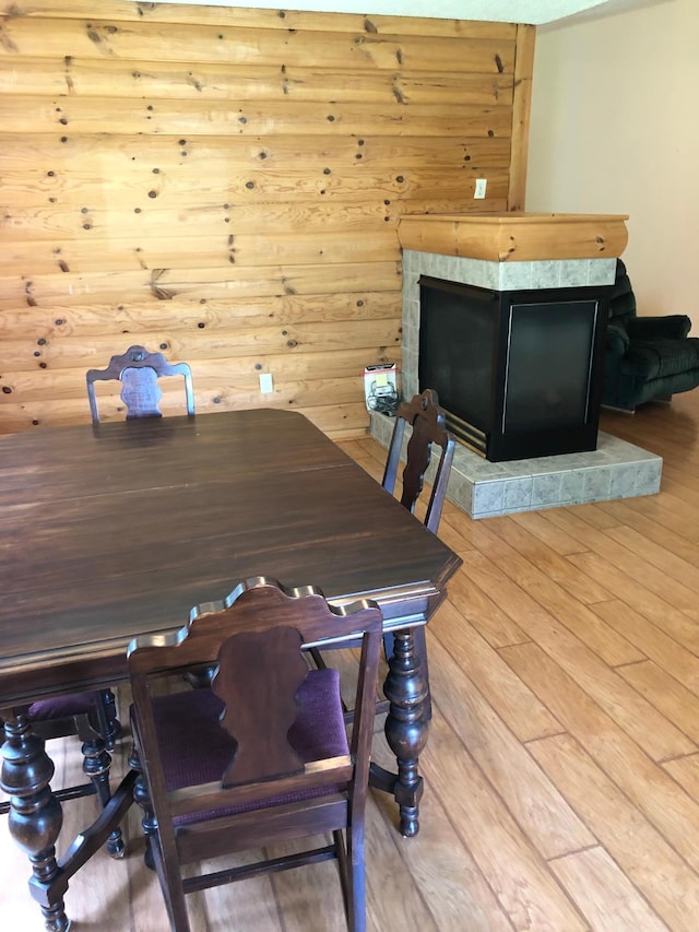 12170 Hillcrest Ct SE, Becker, MN 55308 - dining room featuring a fireplace with raised hearth and light wood-type flooring