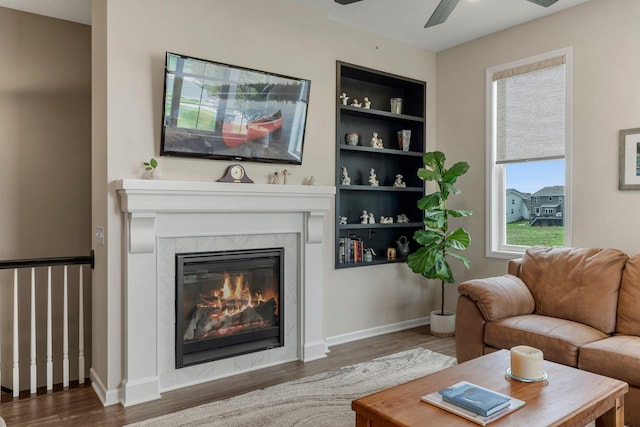 6627 133rd St, Savage, MN 55378 - living area with wood finished floors, ceiling fan, a fireplace, and baseboards