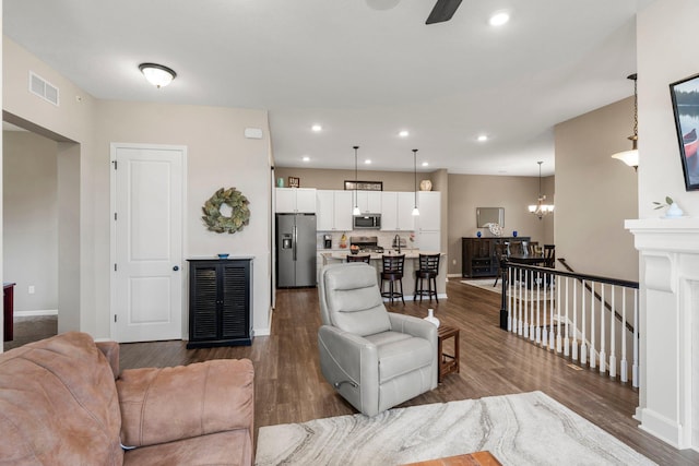 6627 133rd St, Savage, MN 55378 - living area with dark wood-type flooring, baseboards, recessed lighting, and ceiling fan