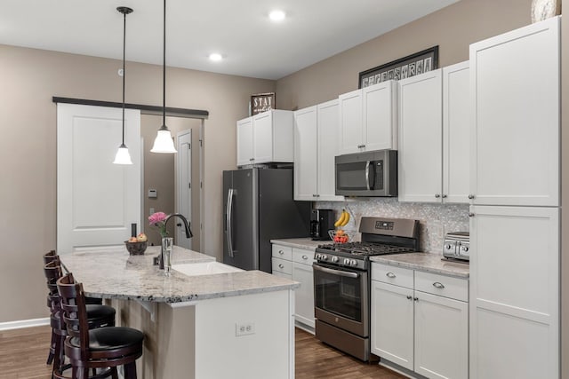 6627 133rd St, Savage, MN 55378 - kitchen with appliances with stainless steel finishes, a sink, dark wood-style flooring, decorative backsplash, and white cabinets