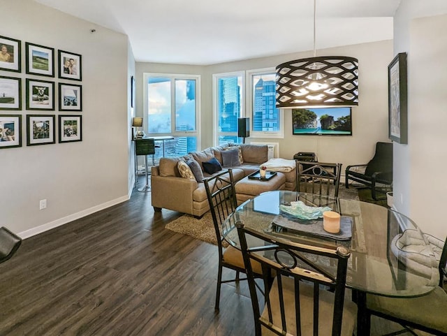 dining room featuring dark wood-type flooring and baseboards