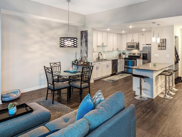 interior space with recessed lighting, baseboards, and dark wood-style flooring