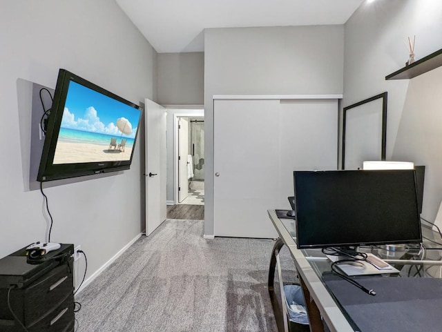 carpeted home office with baseboards