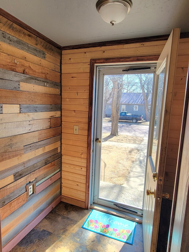 doorway to outside featuring wooden walls