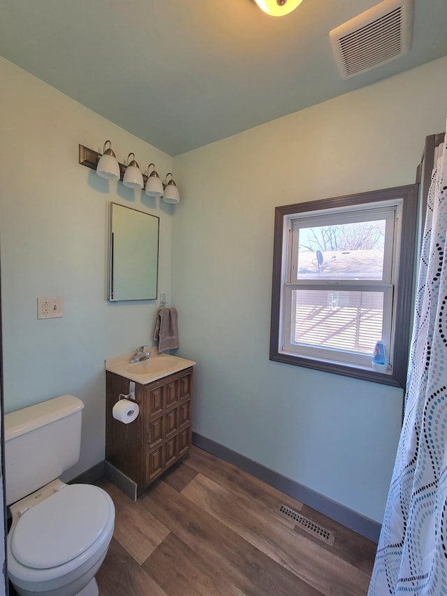 full bath featuring visible vents, toilet, wood finished floors, and vanity