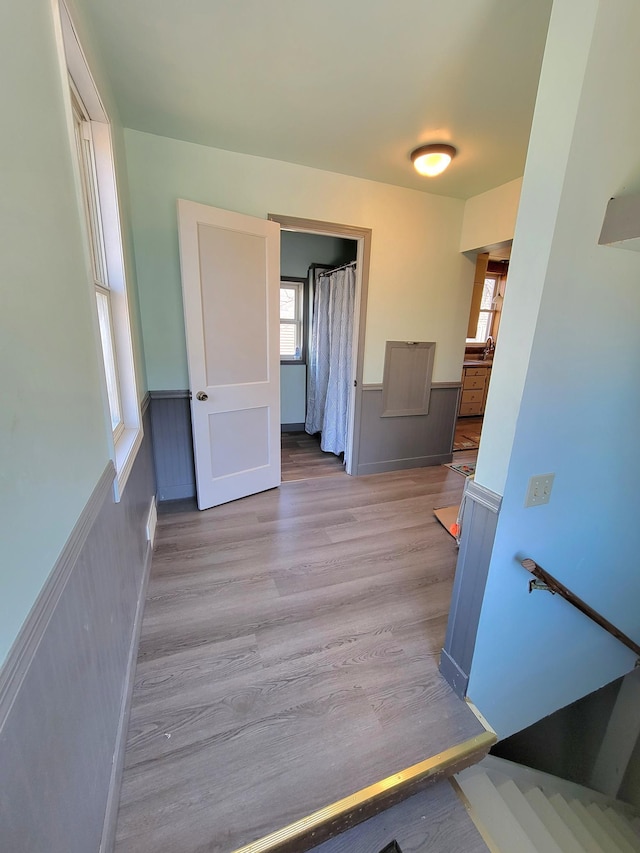 interior space with wainscoting and wood finished floors