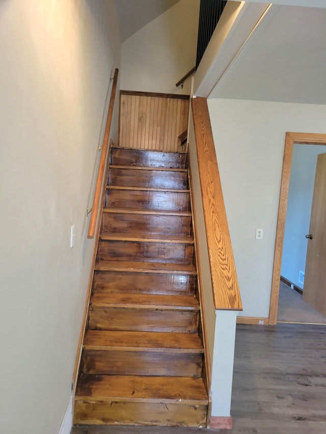 stairs featuring wood finished floors, visible vents, and baseboards