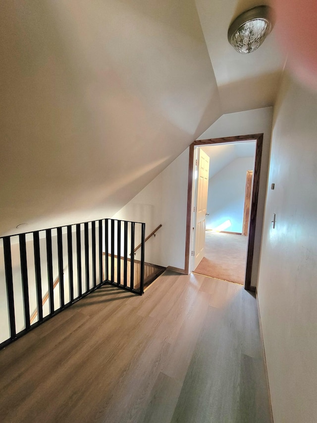 bonus room featuring vaulted ceiling, wood finished floors, and baseboards