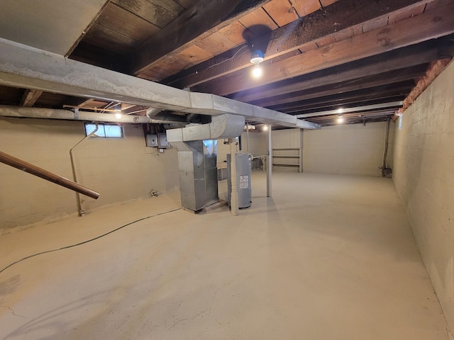 below grade area with heating unit and electric water heater