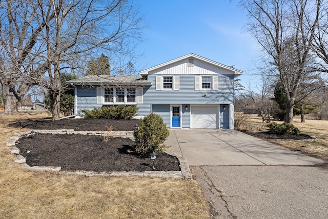 tri-level home with an attached garage and driveway