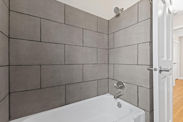 bathroom featuring wood finished floors and shower / bath combination