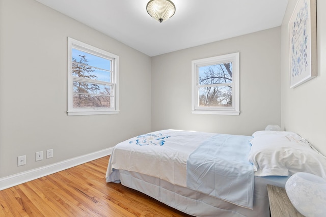 bedroom with baseboards and wood finished floors