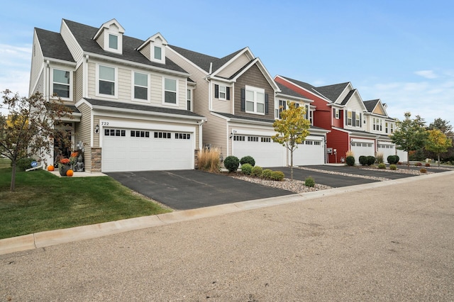 view of front of property with a residential view, driveway, and a garage