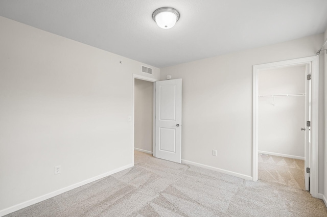 unfurnished bedroom with visible vents, baseboards, and carpet floors