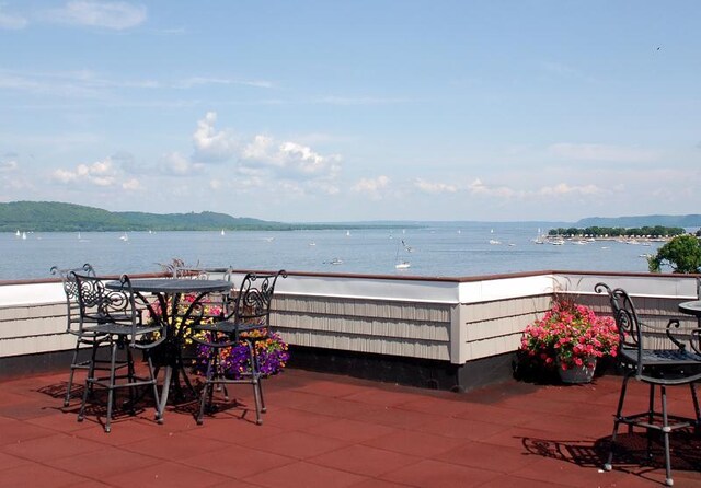 view of patio featuring outdoor dining space and a water view