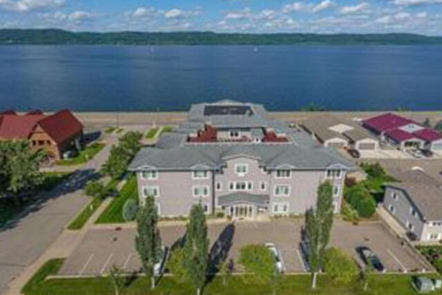 birds eye view of property with a residential view and a water view