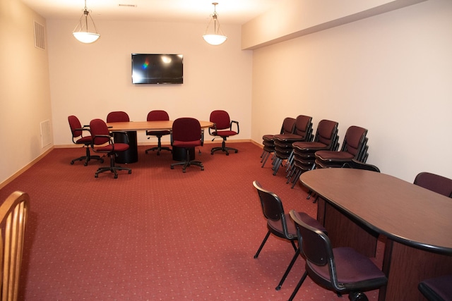 carpeted dining area with visible vents and baseboards