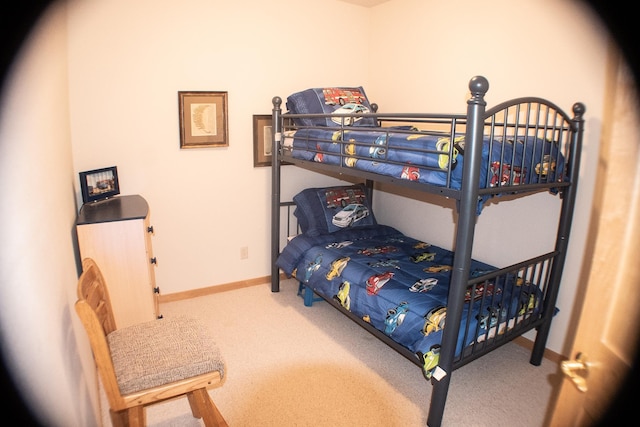 bedroom featuring carpet and baseboards