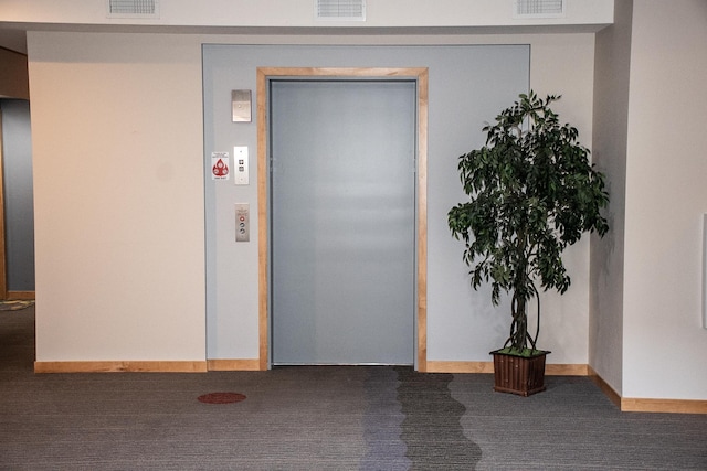 property entrance featuring elevator and visible vents