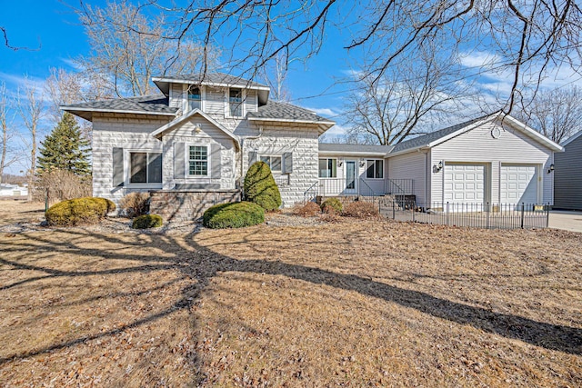 view of front of property with a garage, roof with shingles, and concrete driveway