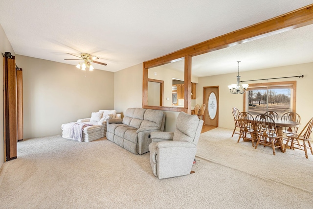 carpeted living room with ceiling fan with notable chandelier and a textured ceiling