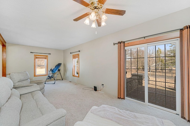 carpeted living room featuring ceiling fan