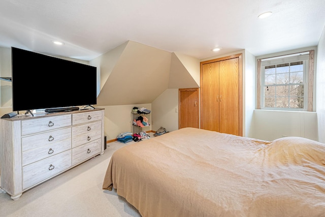 bedroom with light carpet, recessed lighting, a closet, and vaulted ceiling