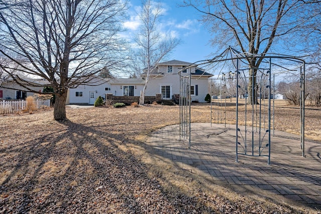 rear view of house with fence