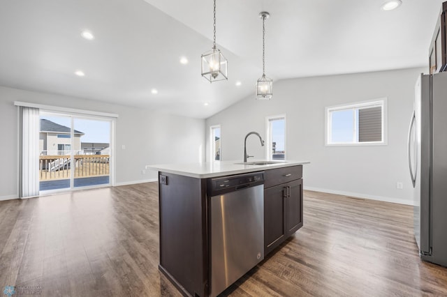 kitchen featuring lofted ceiling, dark wood-style flooring, appliances with stainless steel finishes, and a sink