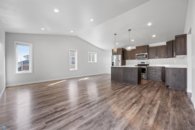 kitchen with dark brown cabinets, a center island, dark wood-type flooring, open floor plan, and stainless steel appliances