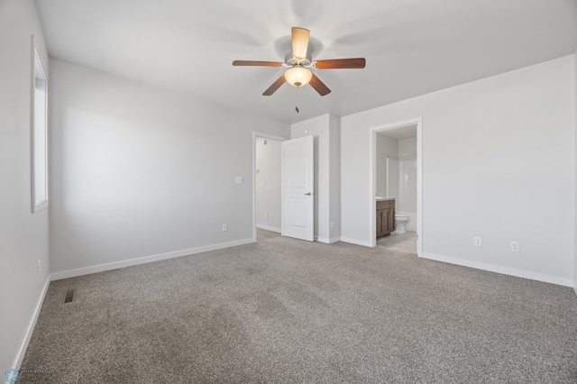 unfurnished bedroom featuring visible vents, light carpet, a ceiling fan, ensuite bath, and baseboards
