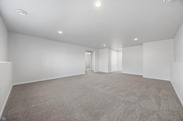 carpeted spare room with recessed lighting and baseboards
