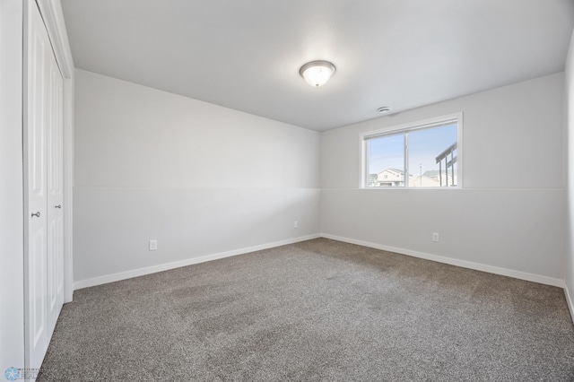 unfurnished bedroom with carpet, baseboards, and a closet