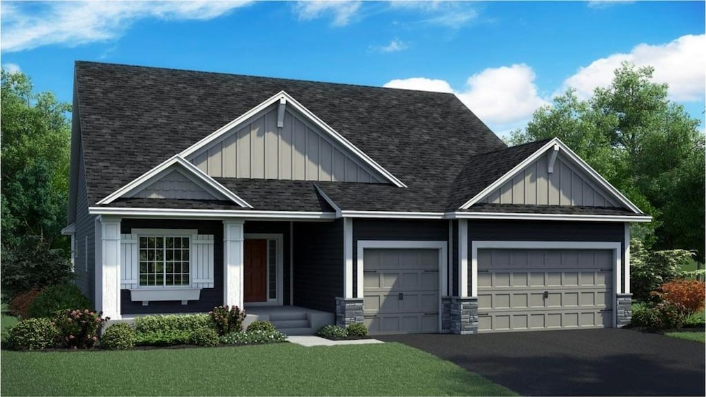 craftsman house featuring board and batten siding, a shingled roof, a front lawn, driveway, and an attached garage