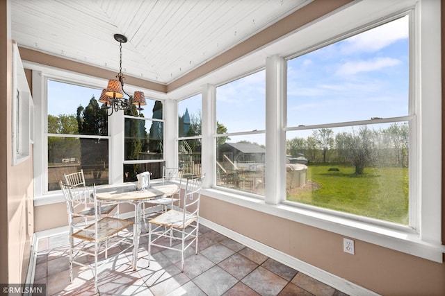 5664 County Road 7 SW, Howard Lake, MN 55349 - sunroom / solarium featuring a tray ceiling, baseboards, stone finish flooring, an inviting chandelier, and wood ceiling