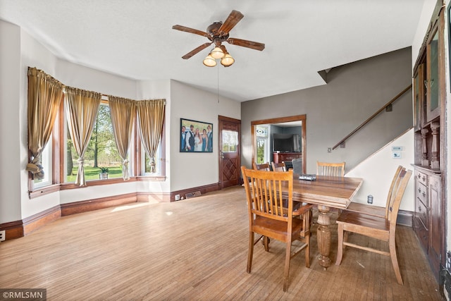 5664 County Road 7 SW, Howard Lake, MN 55349 - dining room with stairway, ceiling fan, baseboards, and wood finished floors