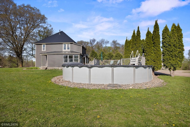 5664 County Road 7 SW, Howard Lake, MN 55349 - exterior space with a covered pool, metal roof, and a lawn